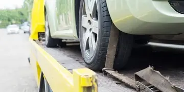 Flatbed tow truck carrying a car in New Orleans